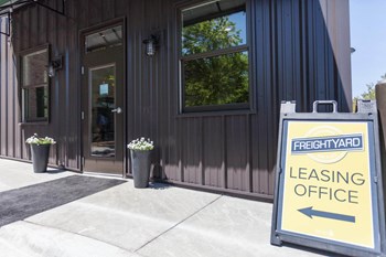Exterior of FreightYard Leasing office with sign pointing to front door. - Photo Gallery 18