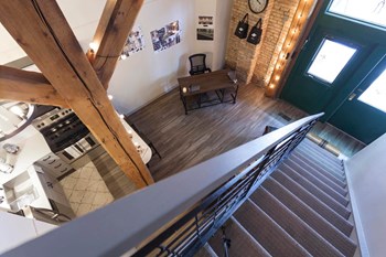 Bird's eye view of entry way from top of staircase showcasing multi-level unit. - Photo Gallery 10
