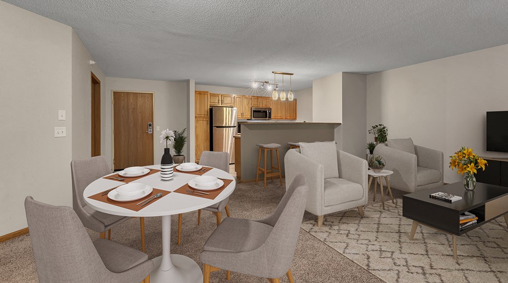 a living room and kitchen with a dining table and chairs