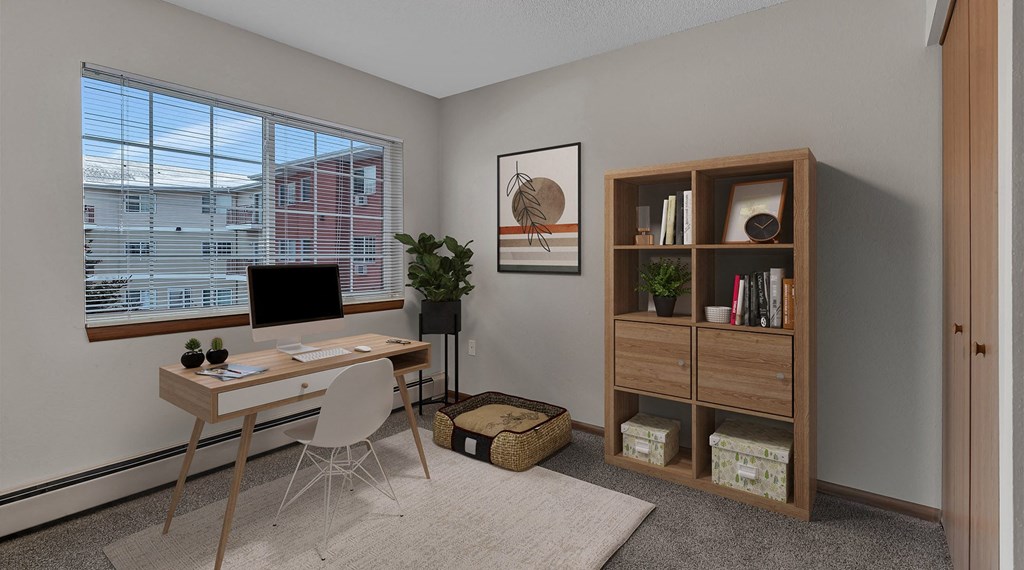 a home office with a desk and a computer and a window