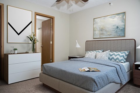 Bedroom with Bed and Dresser and Attached Bathroom