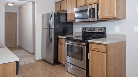 a kitchen with stainless steel appliances and wooden cabinets