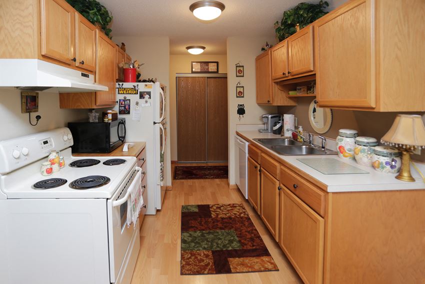 Kitchen with light wood cabinetry and plenty of storage. - Photo Gallery