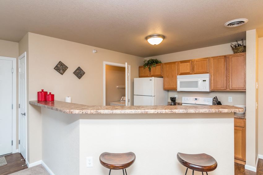 Bright kitchen features a large breakfast bar for casual dining and entertaining. - Photo Gallery