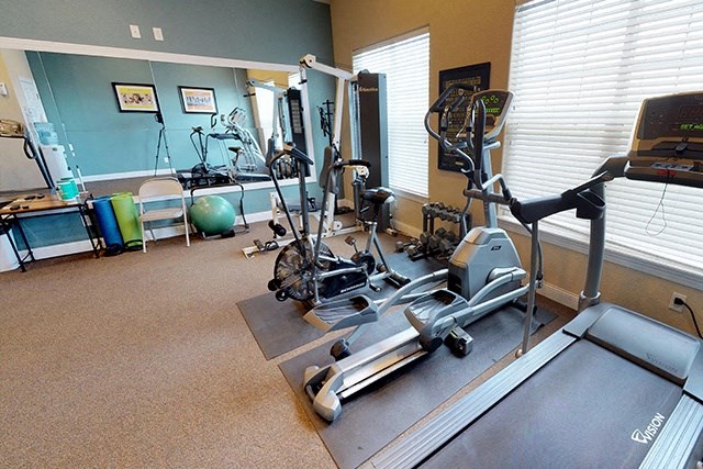 a room filled with lots of different types of exercise equipment