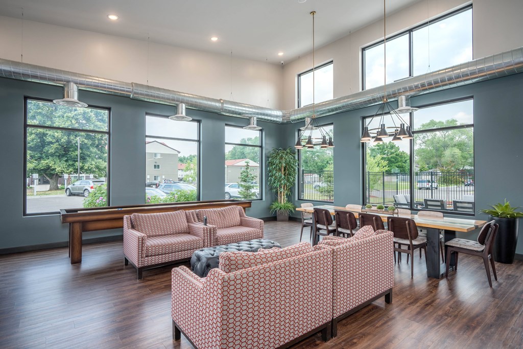 A large room with a long table and chairs.