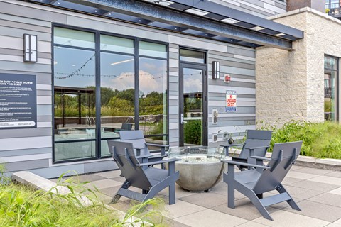A grey building with a glass door and a sign on it.