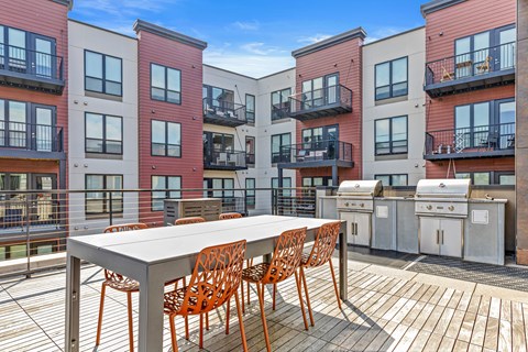 A table with chairs is on a balcony.
