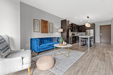 A modern living room with a blue couch and a coffee table.