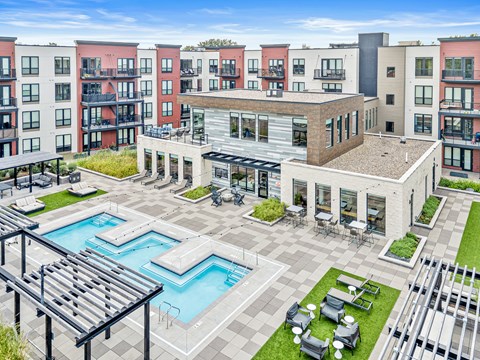 A large building with a pool in the middle of a courtyard.