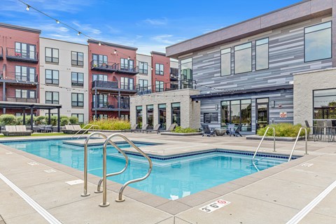 A swimming pool surrounded by apartment buildings.