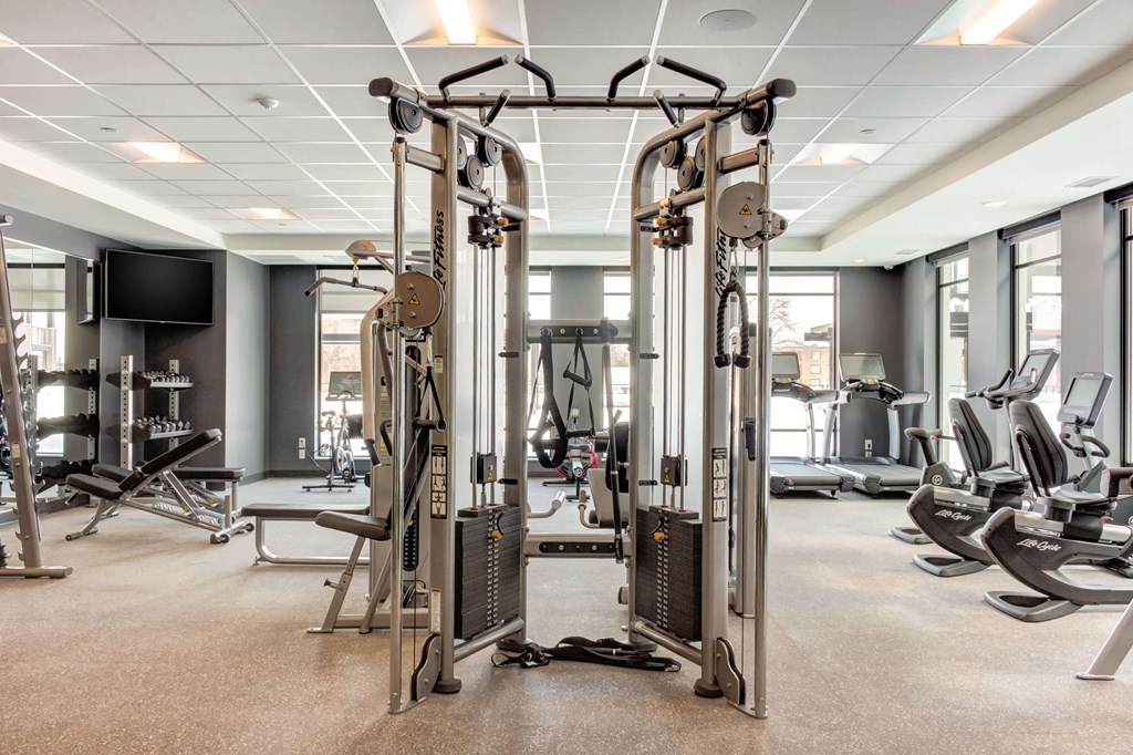 Fitness center with a mirror wall, personal workout equipment, box jumps, and more.