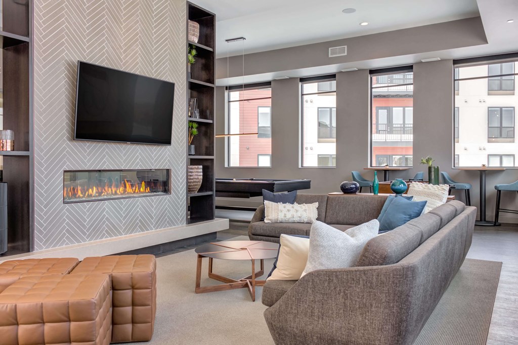 Naturally lit and spacious community space with a fireplace.