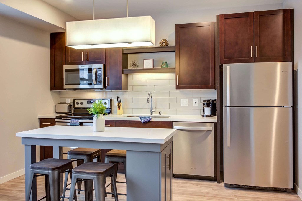 Open kitchen layouts with natural light, open shelving above the sink, and custom islands.