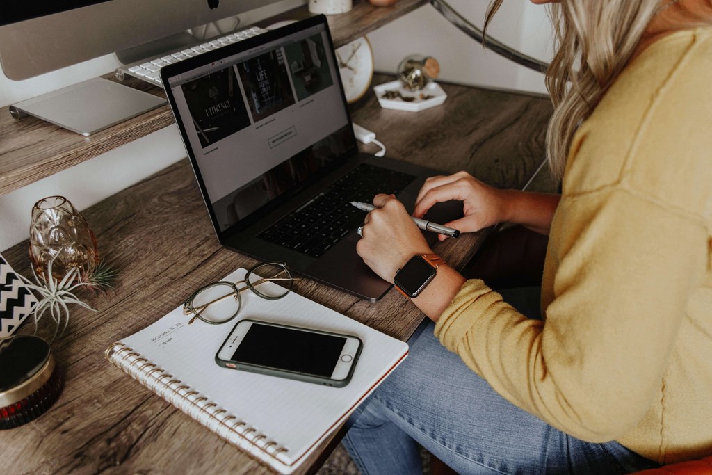 A woman using her laptop as she is working from home.