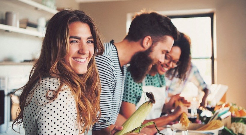 a group of people in a kitchen preparing food