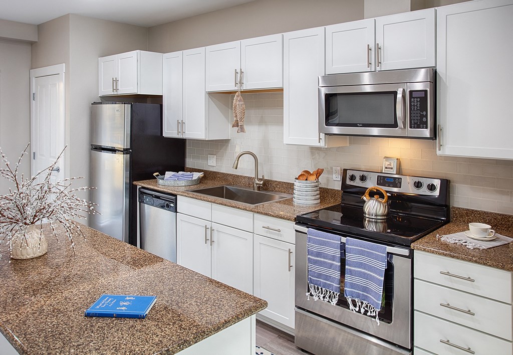a kitchen with stainless steel appliances and granite counter tops