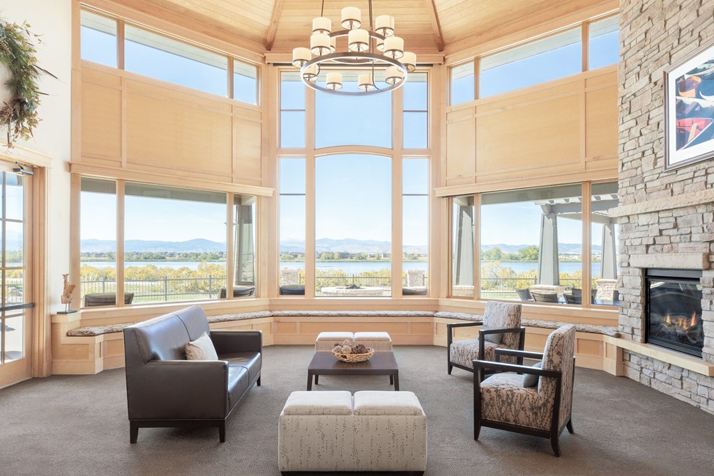 a living room with a fireplace and large windows
