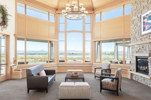 a living room with a fireplace and large windows