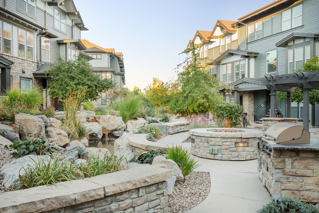 a backyard with a patio and a fire pit
