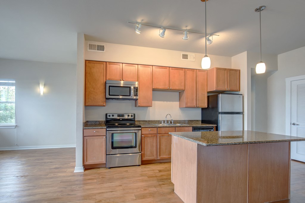 a kitchen with wooden cabinets and stainless steel appliances