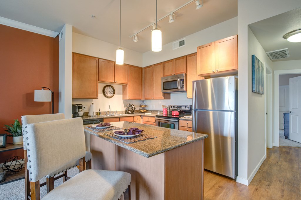 a kitchen with an island and stainless steel appliances