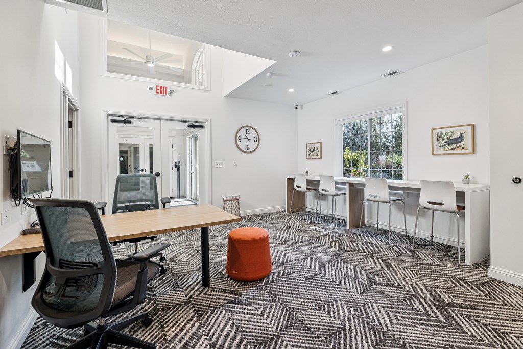 A room with a black chair and a patterned carpet.