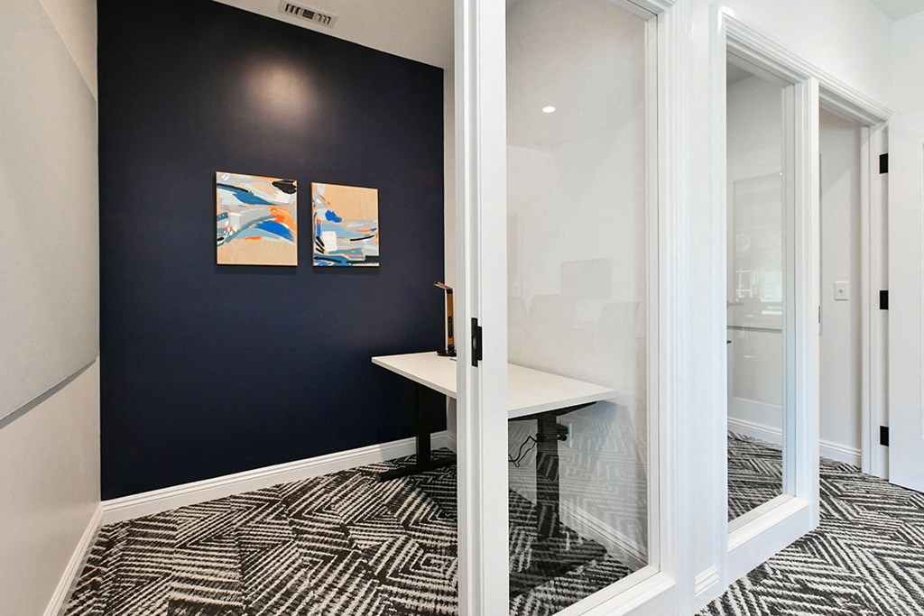 a conference room with a desk and a window