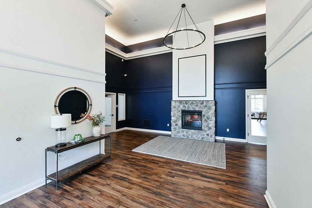 a living room with a fireplace and a blue accent wall