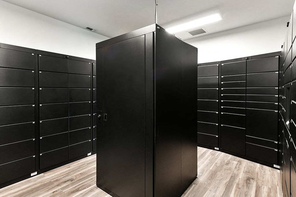 a row of black wardrobes in a room with wooden floors