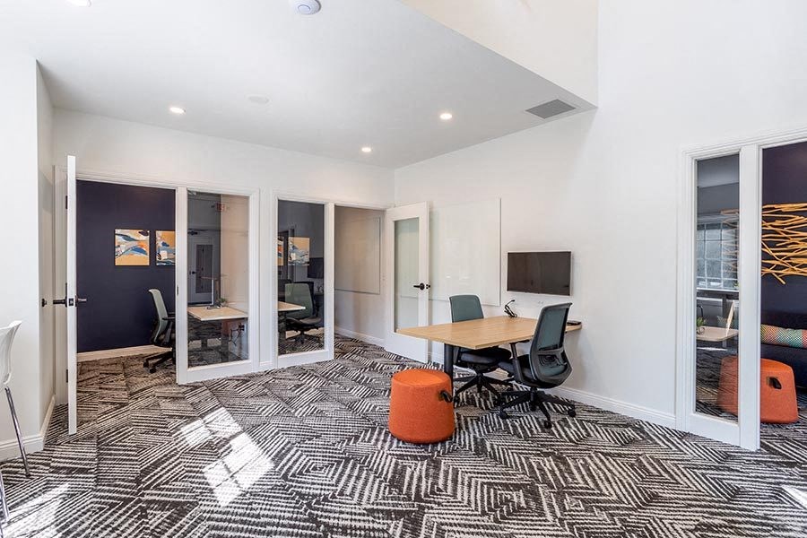 a conference room with a table and a television