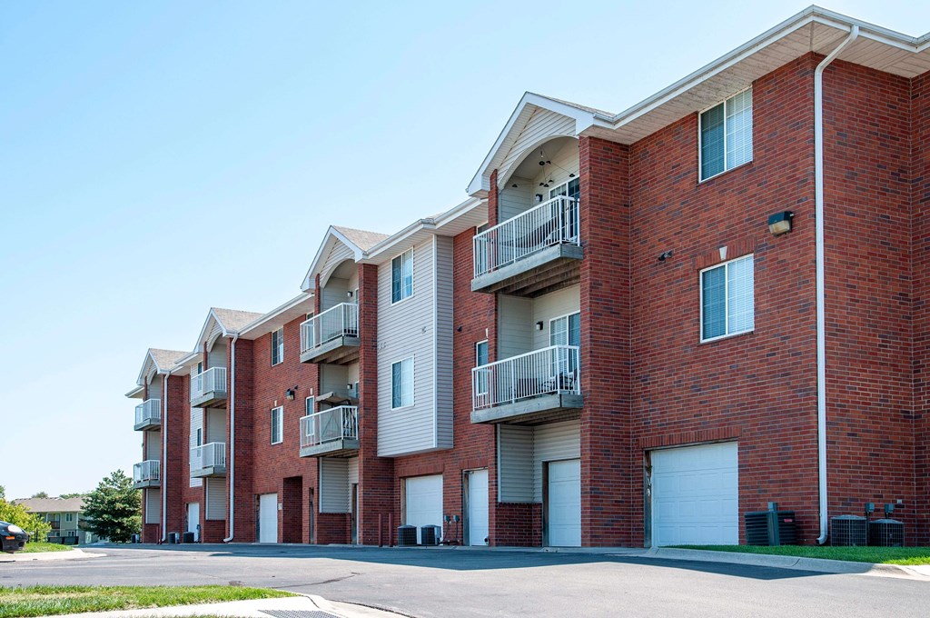 Exterior of select units featuring private garage entrances and driveway.
