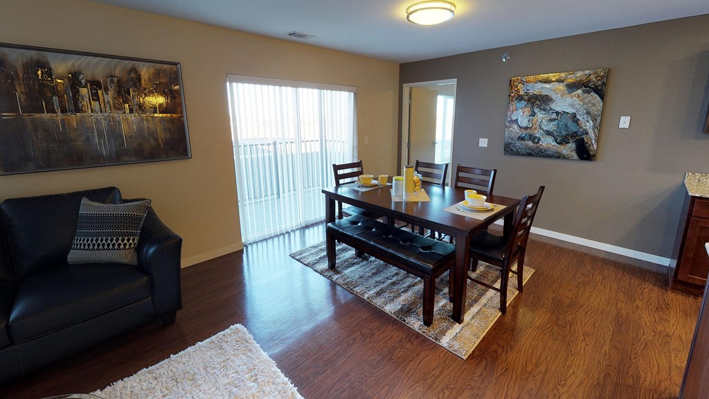 a dining room and living room with a table and chairs