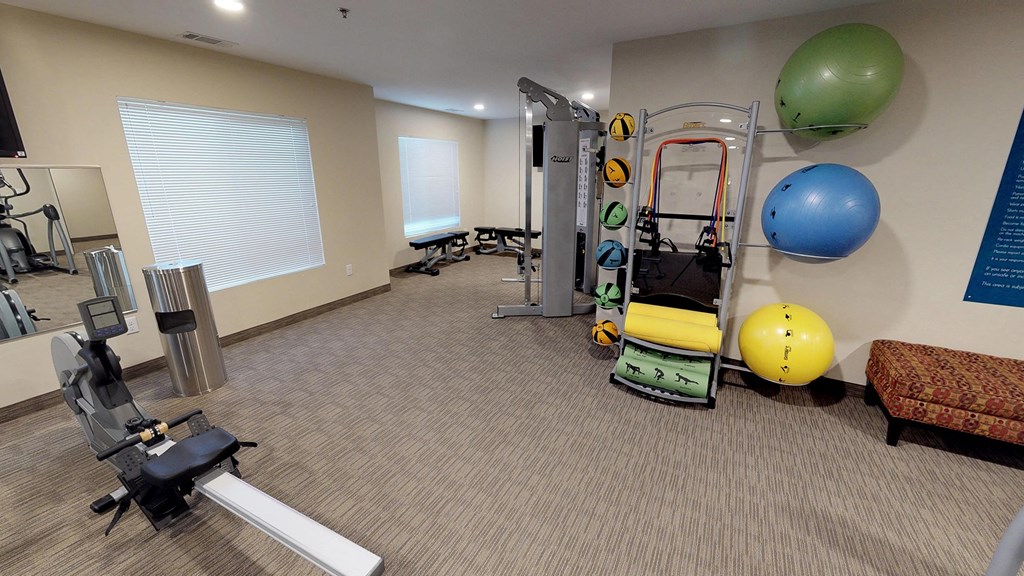 a gym with weights and exercise equipment at the monarch apartments in midtown