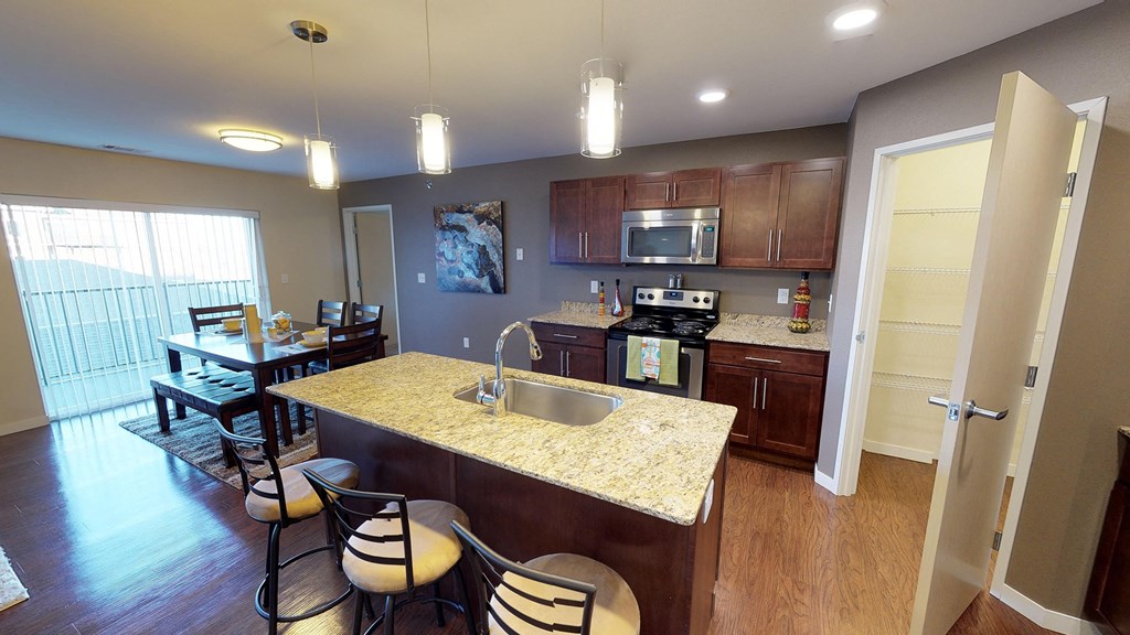 a kitchen and dining room with a granite counter top