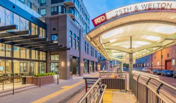 a street view of a building with an entrance to a metro station