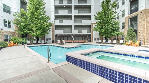 A large swimming pool surrounded by apartment buildings.