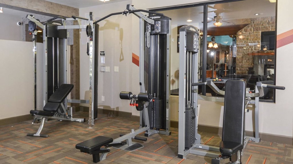 a gym with weights and machines in a hotel room