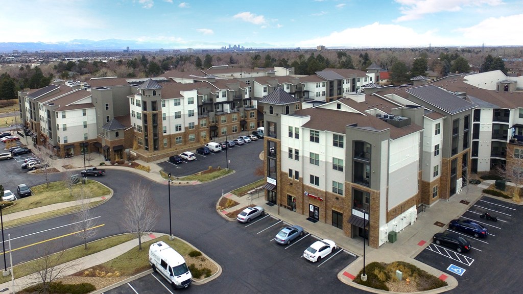an aerial view of an apartment complex with cars parked in a parking lot