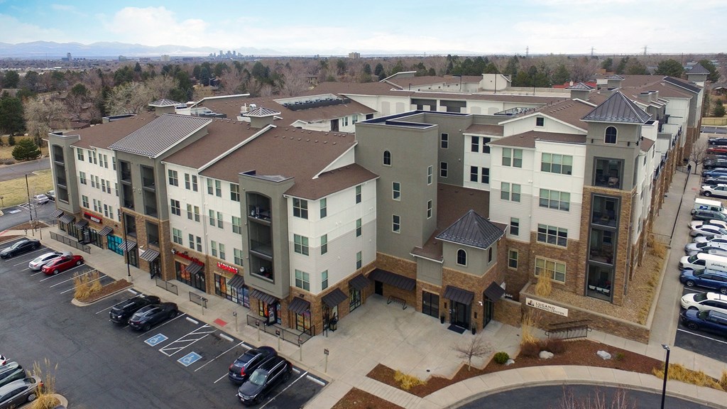 an aerial view of an apartment complex with a parking lot