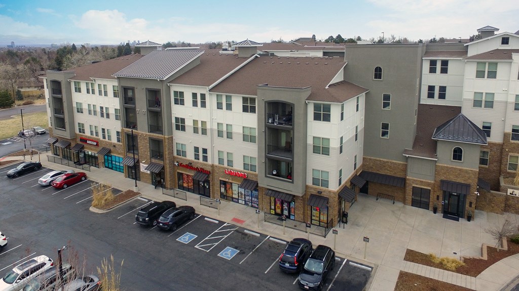 an aerial view of an apartment building in a parking lot