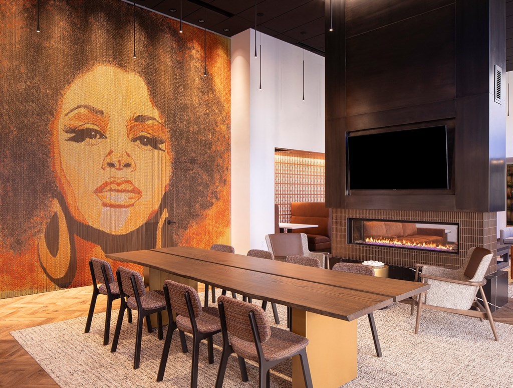 a conference room with a large painting of a woman on the wall
