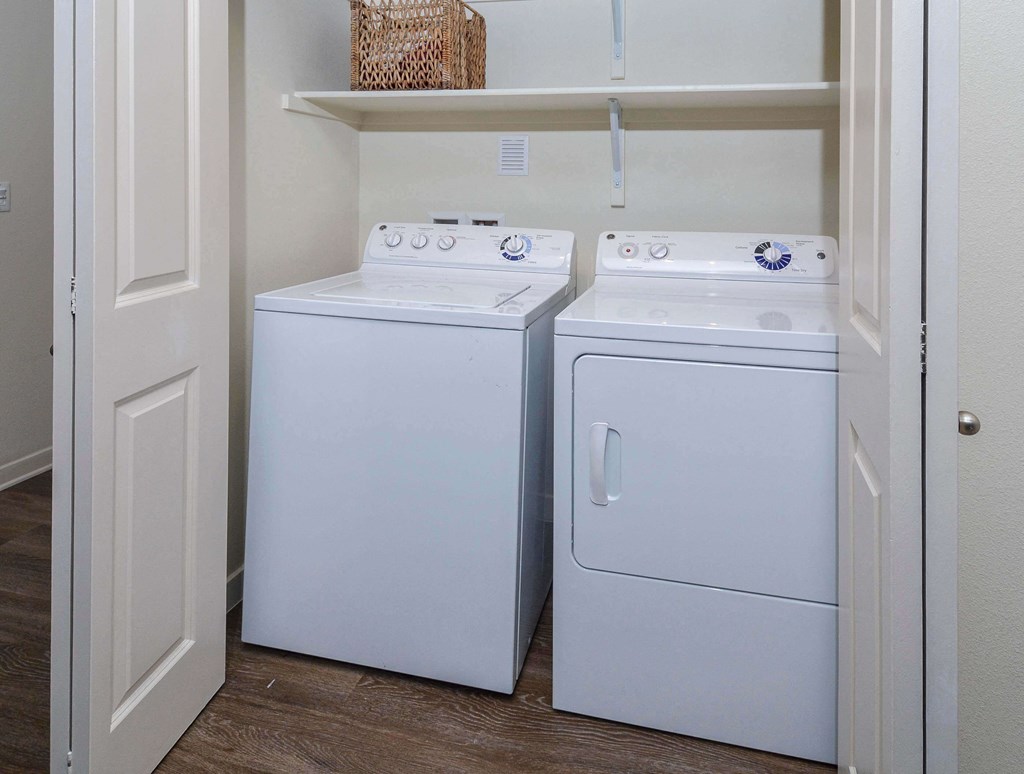 Convenient closet housing in unit washer and dryer side by side.