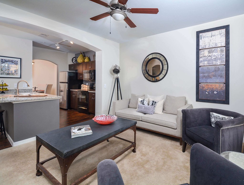Well lit open living room that leads into the modern kitchen.