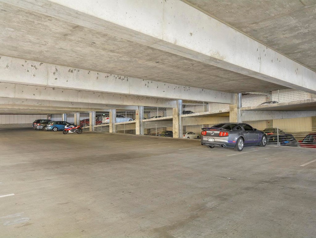 Private covered parking garage with overhead lighting.