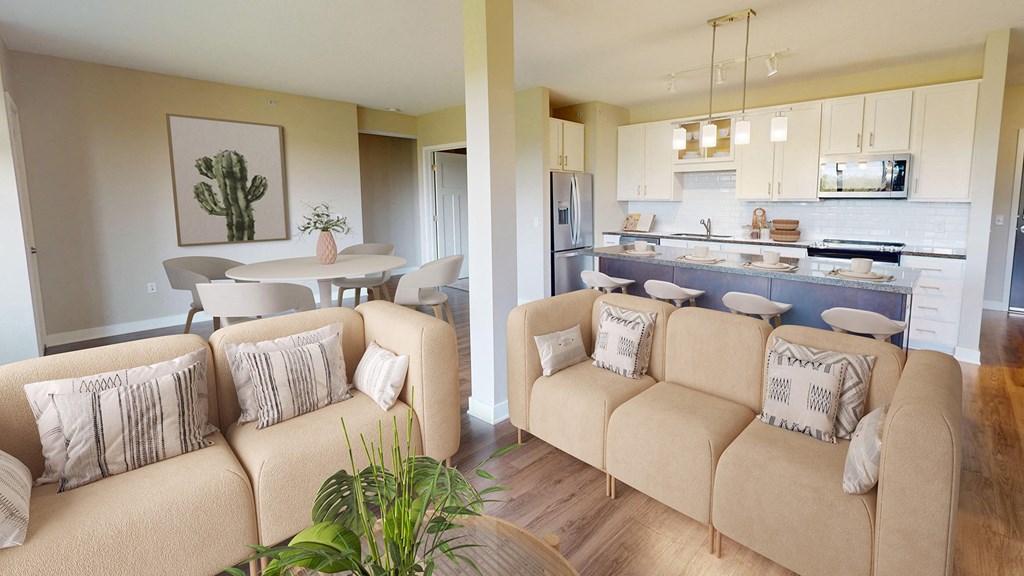 A living room with a couch and a dining area in the background.