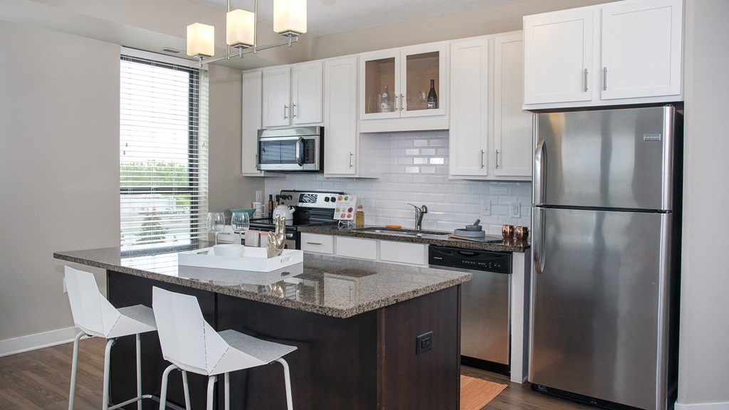 a kitchen with stainless steel appliances and a granite counter top