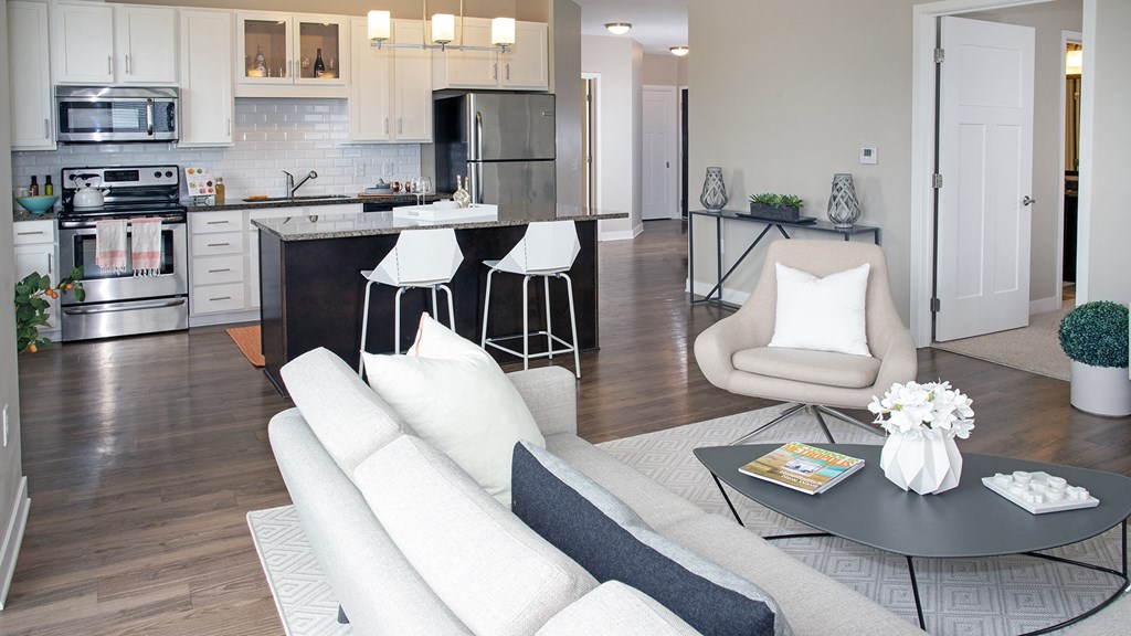 a living room and kitchen with a couch and a table