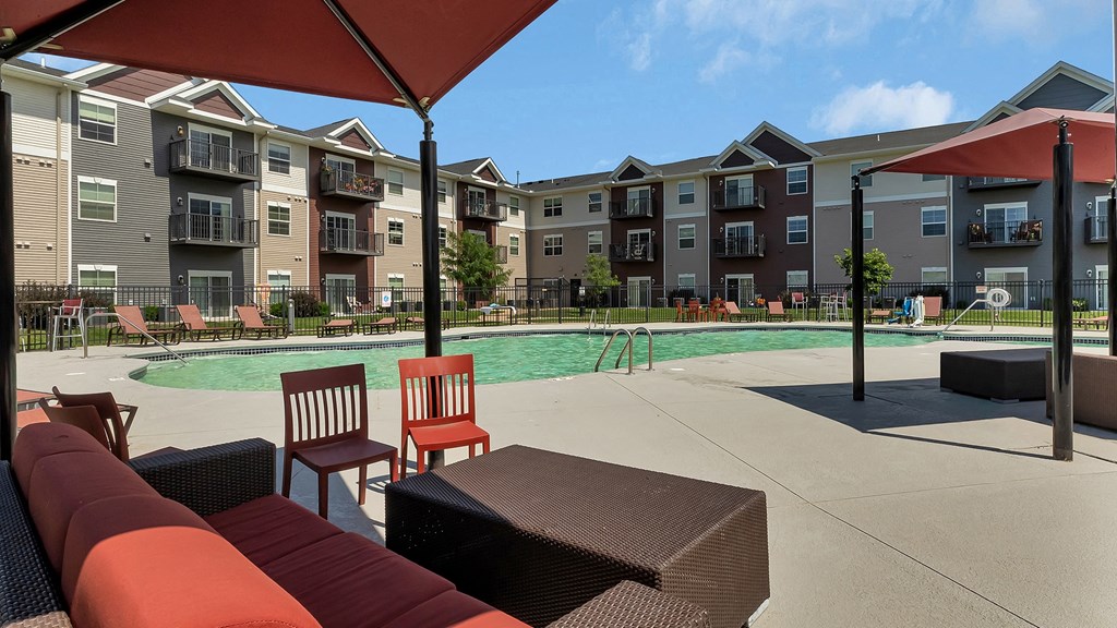 our apartments have a large pool area with furniture and tables