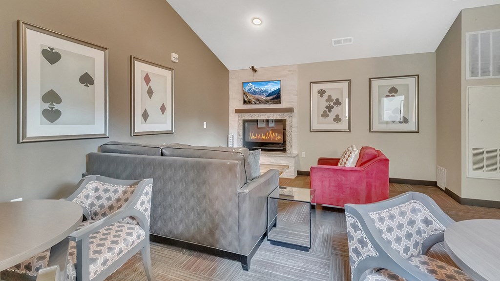 a living room with couches and chairs and a fireplace